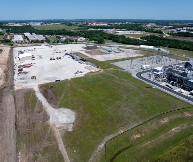 A North Texas industrial site from a drone, with a substation beside a cleared lot